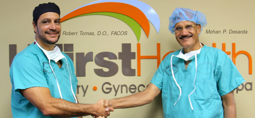 Dr. Robert Tomas shaking hands with Dr. Desarda