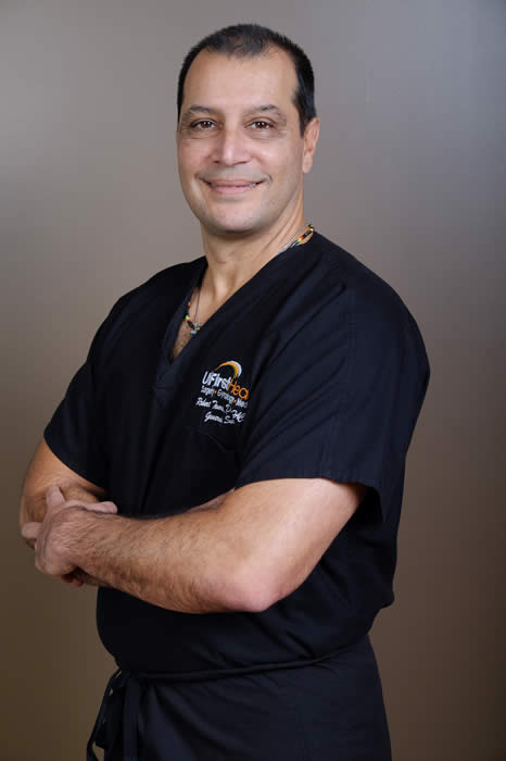 Dr. Robert Tomas in scrubs